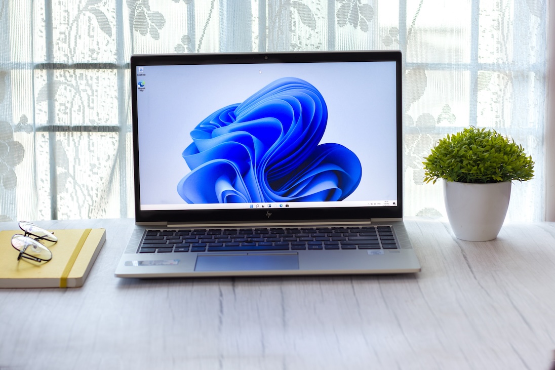 Tafel met laptop met op scherm windows 11 logo